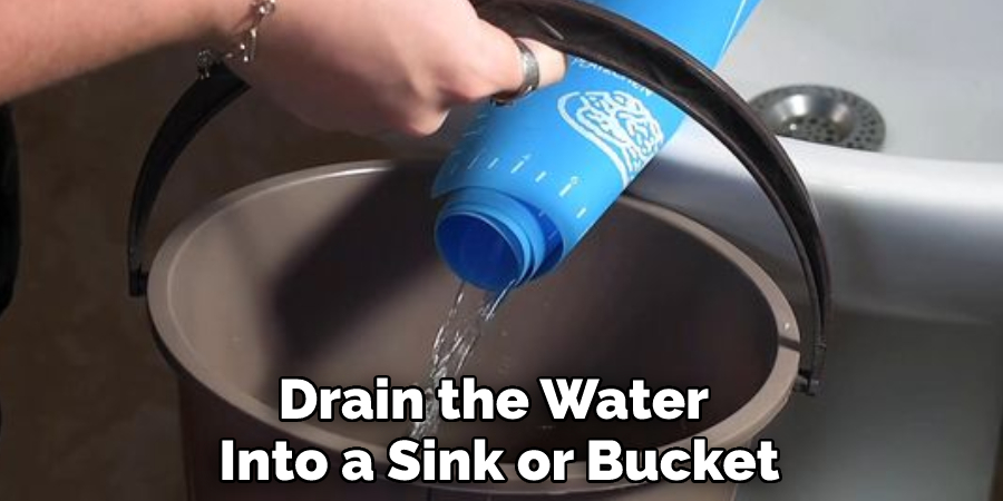 Drain the Water Into a Sink or Bucket