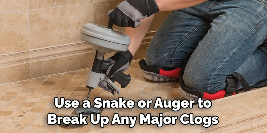Use a Snake or Auger to Break Up Any Major Clogs