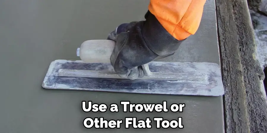 Use a Trowel or Other Flat Tool