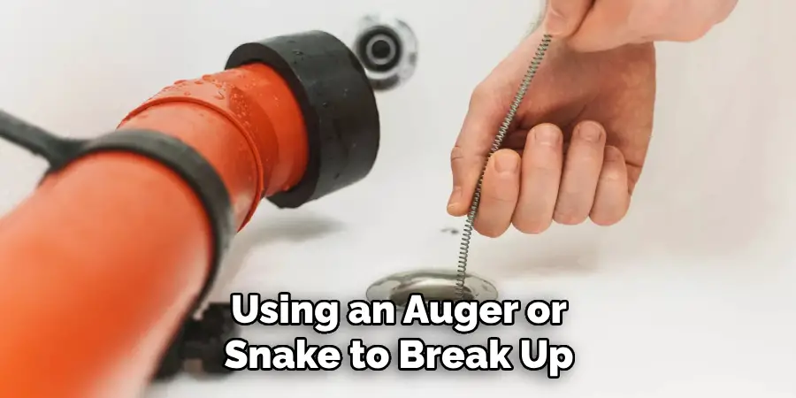 Using an Auger or Snake to Break Up